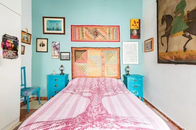 a bedroom with a large bed and blue cabinets at Habitaciones La Pepa in Cádiz