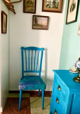 a blue chair sitting next to a blue dresser at Habitaciones La Pepa in Cádiz