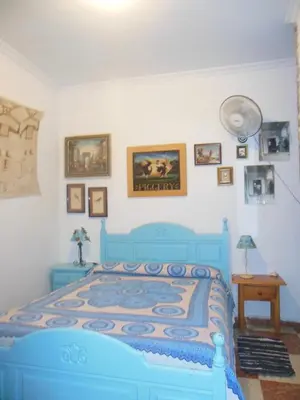 a bedroom with a blue bed in a room at Habitaciones La Pepa in Cádiz