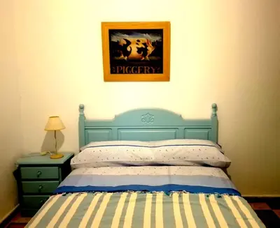 a bedroom with a bed and a picture on the wall at Habitaciones La Pepa in Cádiz