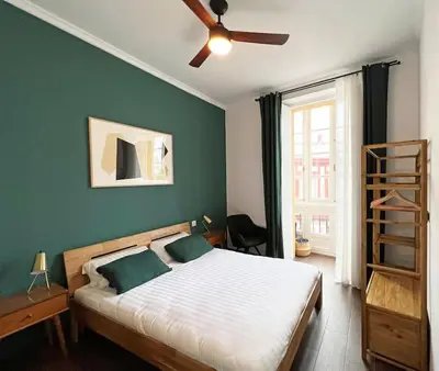 a bedroom with a bed and a ceiling fan at Casa Odisea Cádiz in Cádiz