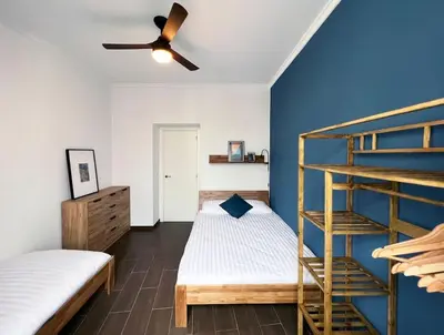 a bedroom with two bunk beds and a ceiling fan at Casa Odisea Cádiz in Cádiz