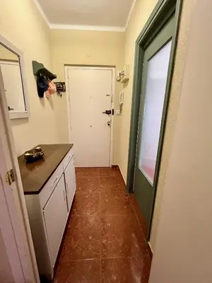 a room with a kitchen with a door and a counter at Luz, sol y arena in Rota