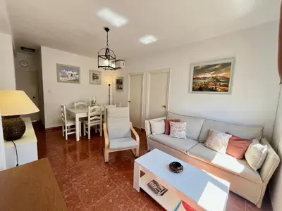 a living room with a couch and a table at Luz, sol y arena in Rota