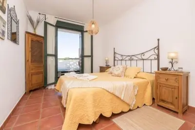 a bedroom with a large bed and a window at apartamento playa la barrosa in Chiclana de la Frontera