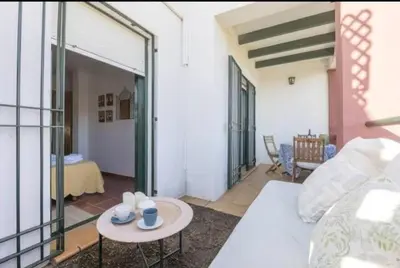 a living room with a couch and a table at apartamento playa la barrosa in Chiclana de la Frontera