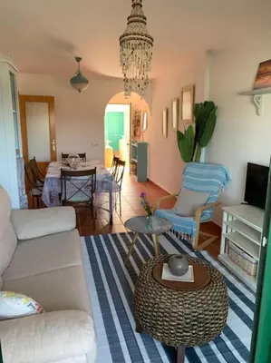 a living room with a couch and a table at apartamento playa la barrosa in Chiclana de la Frontera