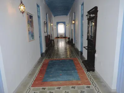 a hallway with a rug on the floor of a building at Hotel La Fonda del Califa in Arcos de la Frontera
