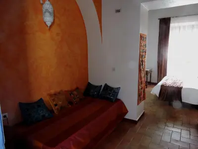 a bedroom with a bed in a room with a window at Hotel La Fonda del Califa in Arcos de la Frontera