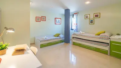 a room with two beds and a table in it at Villa Italia Conil de la Frontera by Ruralidays in Conil de la Frontera