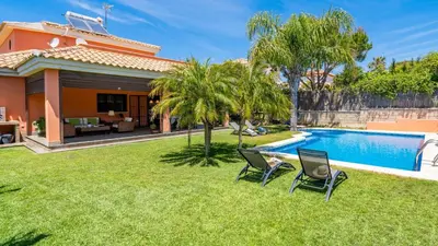 a backyard with a swimming pool and a house at Villa Italia Conil de la Frontera by Ruralidays in Conil de la Frontera