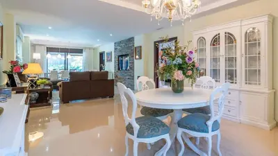 a living room with a table with a vase of flowers at Villa Italia Conil de la Frontera by Ruralidays in Conil de la Frontera