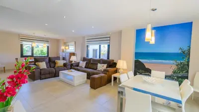 a living room with a couch and a table at Villa Mónaco Conil de la Frontera by Ruralidays in Conil de la Frontera