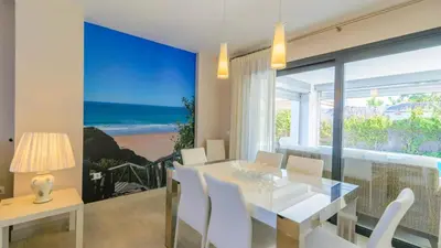 a dining room with a table and a view of the ocean at Villa Mónaco Conil de la Frontera by Ruralidays in Conil de la Frontera