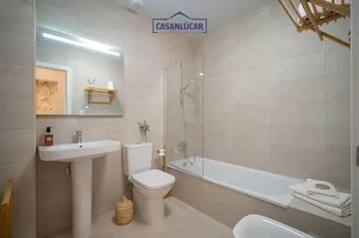 a bathroom with a sink and a toilet and a bath tub at Casa Alcoba de la luz in Sanlúcar de Barrameda