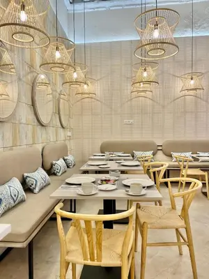 a dining room with tables and chairs and chandeliers at Soho Boutique Cádiz in Cádiz