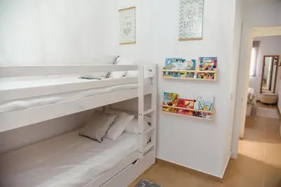 a room with two bunk beds in it at Apartamento Residencial Punta Candor in Rota