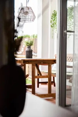 a dining room table with a potted plant on it at Apartamento Residencial Punta Candor in Rota