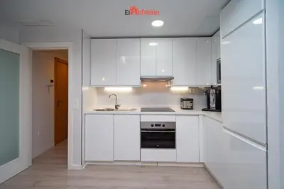 a kitchen with white cabinets and a sink at El Anfitrión - Barra del río in Sanlúcar de Barrameda