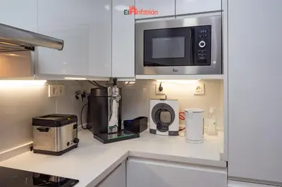 a kitchen with a microwave and a coffee maker at El Anfitrión - Barra del río in Sanlúcar de Barrameda