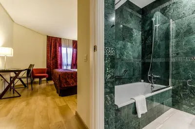 a bathroom with a shower and a bath tub in a room at Exe Guadalete in Jerez de la Frontera