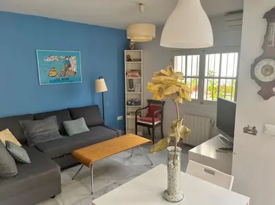 a living room with a couch and a table at PENTHOUSE WITH LARGE TERRACE IN CENTER OF CÁDIZ in Cádiz