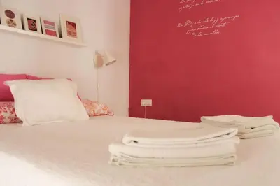 a white bed with two white towels on it at PENTHOUSE WITH LARGE TERRACE IN CENTER OF CÁDIZ in Cádiz