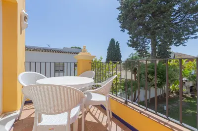 a patio with a table and chairs on a balcony at Apartamentos Soho Boutique Vistahermosa in El Puerto de Santa María