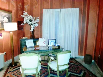 a room with a glass desk and two chairs at Soho Boutique Vistahermosa in El Puerto de Santa María
