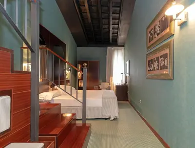 a bedroom with a bed and a staircase in it at Soho Boutique Jerez in Jerez de la Frontera