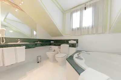 a bathroom with a toilet and a tub and a sink at Soho Boutique Jerez in Jerez de la Frontera