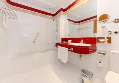 a bathroom with a red sink and a bath tub at Soho Boutique Jerez in Jerez de la Frontera