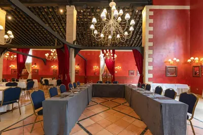 a dining room with a long table and a chandelier at Soho Boutique Jerez in Jerez de la Frontera