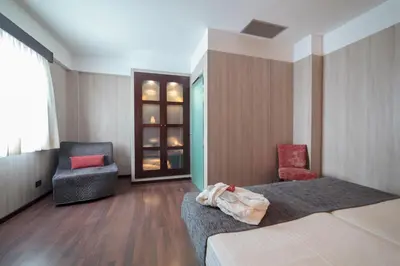 a hotel room with two beds and a chair at Hotel Salymar in San Fernando