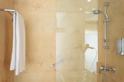 a bathroom with a shower with a glass door at Hotel Salymar in San Fernando