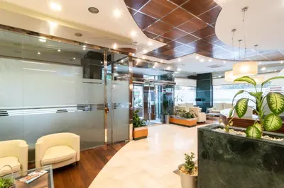 a lobby of an office with chairs and plants at Hotel Regio Cádiz in Cádiz