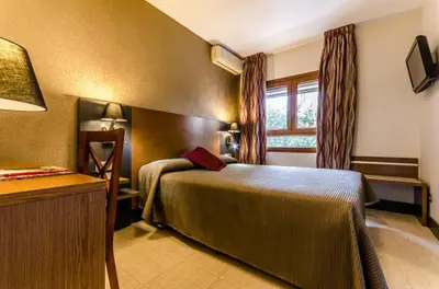 a hotel room with a bed and a window at Hotel Regio Cádiz in Cádiz
