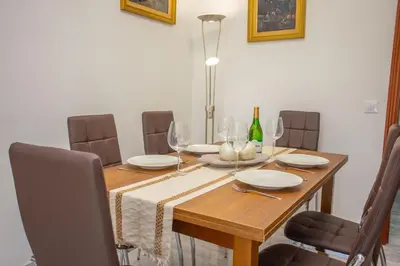 a dining room table with chairs and wine glasses at Wehost-costaluz Apartamento Sanlúcar con parking in Sanlúcar de Barrameda