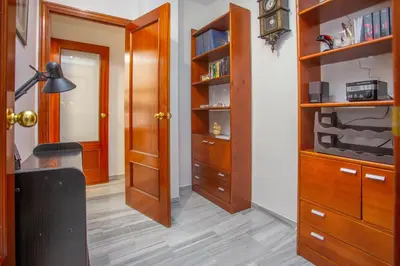 a room with a closet with wooden shelves and a door at Wehost-costaluz Apartamento Sanlúcar con parking in Sanlúcar de Barrameda