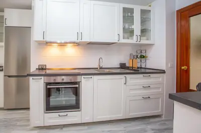 a kitchen with white cabinets and a sink at Wehost-costaluz Apartamento Sanlúcar con parking in Sanlúcar de Barrameda