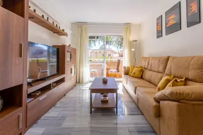 a living room with a couch and a tv at Wehost-costaluz Apartamento Sanlúcar con parking in Sanlúcar de Barrameda