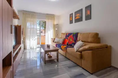 a living room with a couch and a table at Wehost-costaluz Apartamento Sanlúcar con parking in Sanlúcar de Barrameda