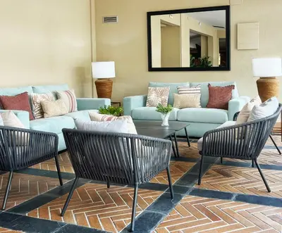 a living room with a blue couch and chairs at Soho Boutique Puerto in El Puerto de Santa María