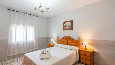 a bedroom with a bed with two towels on it at Los Arcángeles Chiclana de la Frontera by Ruralidays in Chiclana de la Frontera