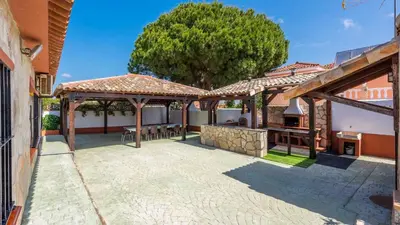 an outdoor patio with a grill and a tree at Los Arcángeles Chiclana de la Frontera by Ruralidays in Chiclana de la Frontera