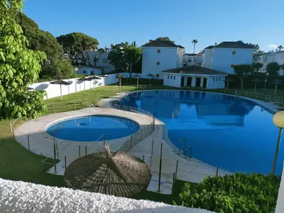 a large swimming pool in front of some buildings at SOLEA 17 in Rota