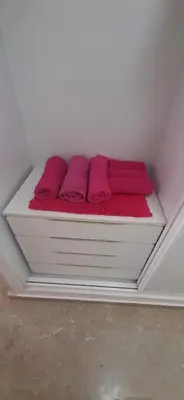 a bed in a room with pink pillows on it at SOLEA 17 in Rota
