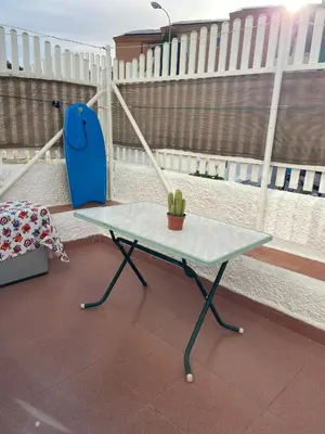 a table and a chair on top of a balcony at SOLEA 17 in Rota