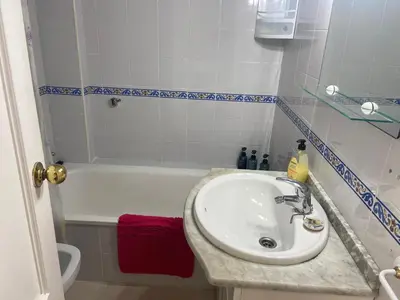 a bathroom with a sink and a bath tub at SOLEA 17 in Rota