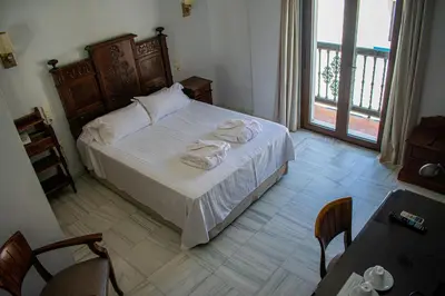a bedroom with a bed with towels on it at Hotel Playa de Regla in Chipiona